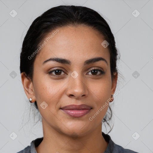 Joyful latino young-adult female with medium  brown hair and brown eyes