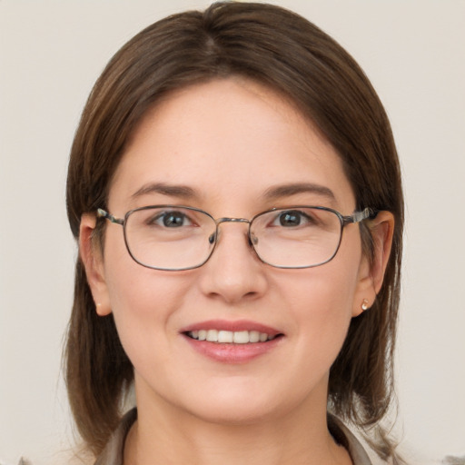 Joyful white young-adult female with medium  brown hair and grey eyes