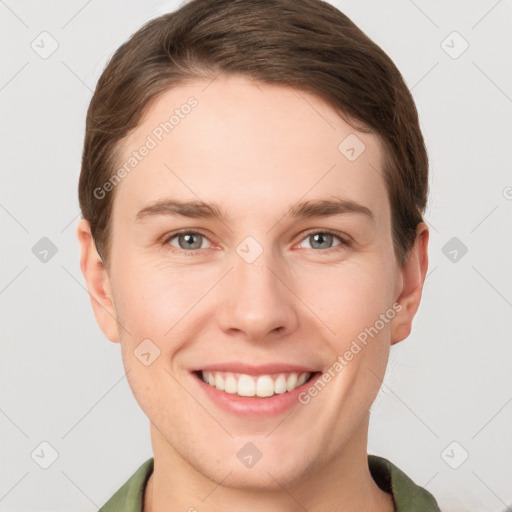 Joyful white young-adult female with short  brown hair and grey eyes