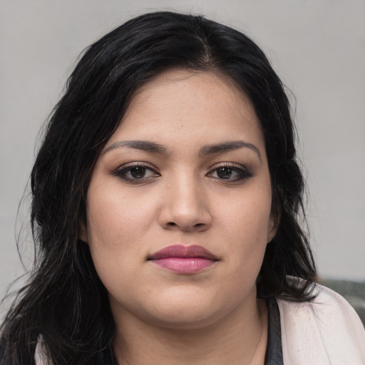 Joyful latino young-adult female with long  black hair and brown eyes