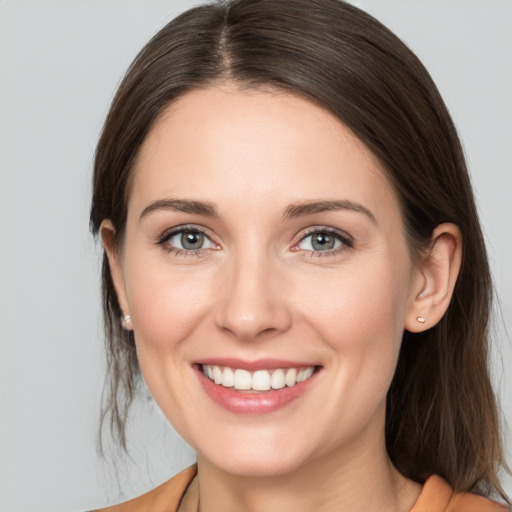 Joyful white young-adult female with medium  brown hair and brown eyes