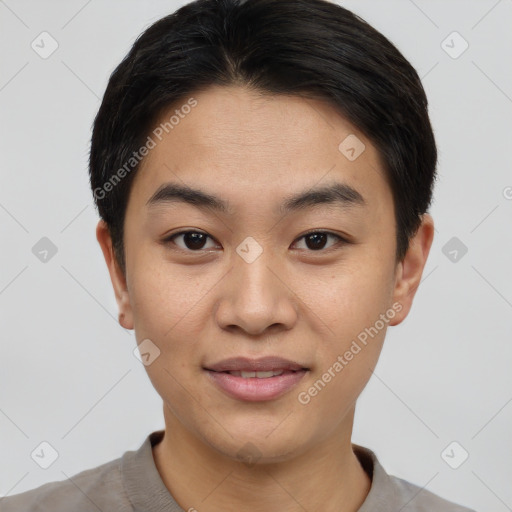 Joyful asian young-adult male with short  black hair and brown eyes