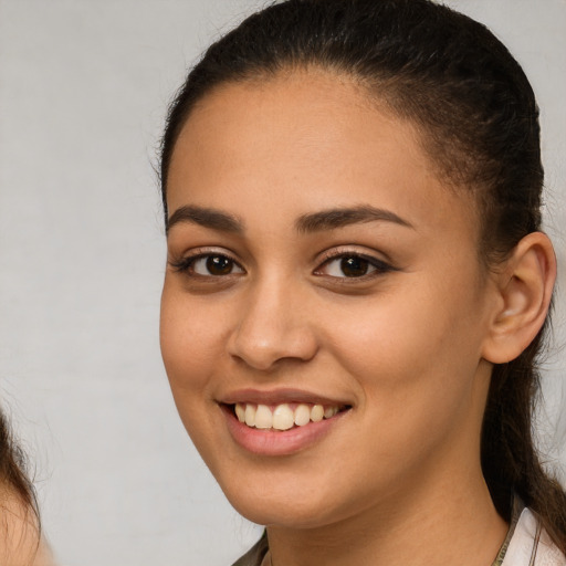 Joyful white young-adult female with long  brown hair and brown eyes