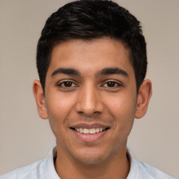 Joyful white young-adult male with short  black hair and brown eyes