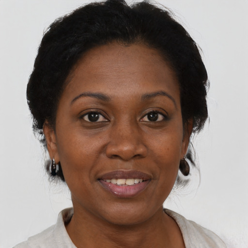 Joyful black adult female with short  brown hair and brown eyes