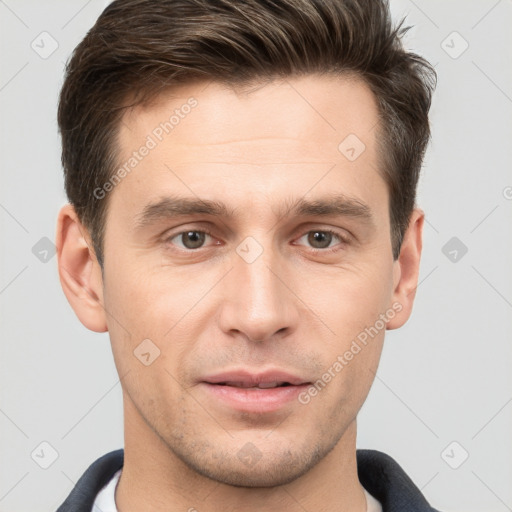 Joyful white young-adult male with short  brown hair and grey eyes