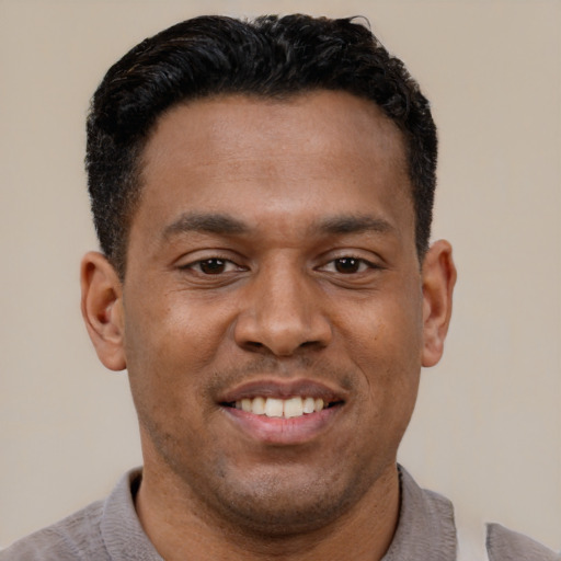 Joyful latino young-adult male with short  brown hair and brown eyes