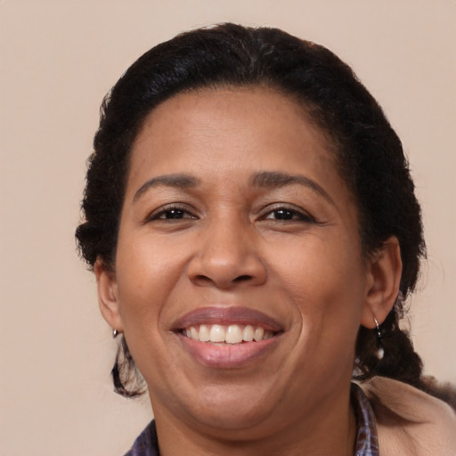 Joyful black adult female with medium  brown hair and brown eyes