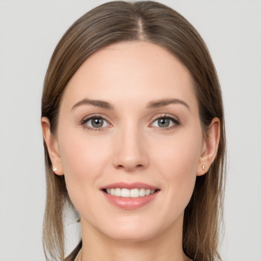 Joyful white young-adult female with long  brown hair and grey eyes