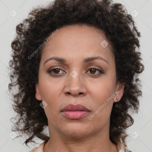 Joyful black adult female with medium  brown hair and brown eyes