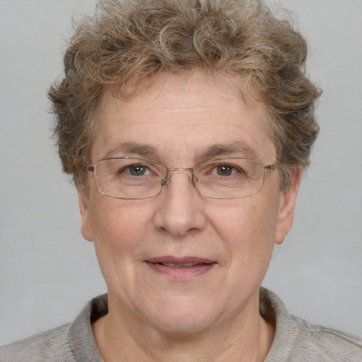 Joyful white middle-aged female with short  brown hair and blue eyes