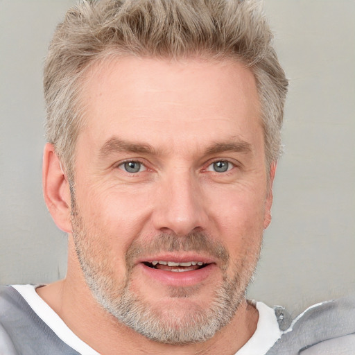 Joyful white adult male with short  brown hair and grey eyes