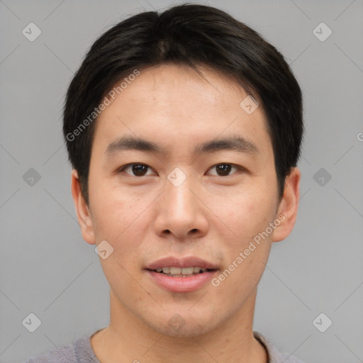 Joyful asian young-adult male with short  brown hair and brown eyes