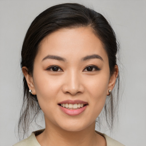 Joyful asian young-adult female with medium  brown hair and brown eyes