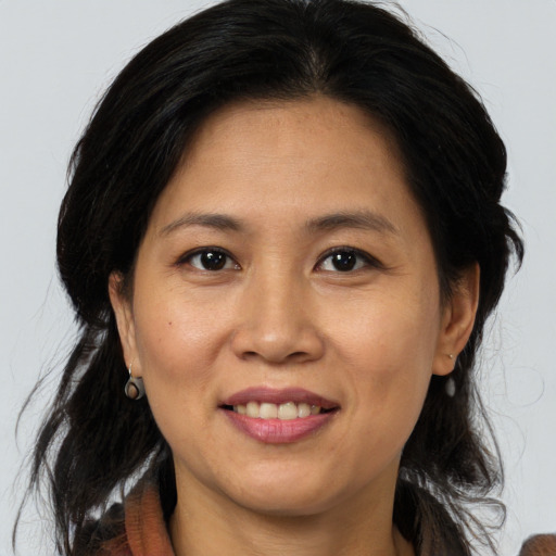 Joyful asian adult female with medium  brown hair and brown eyes