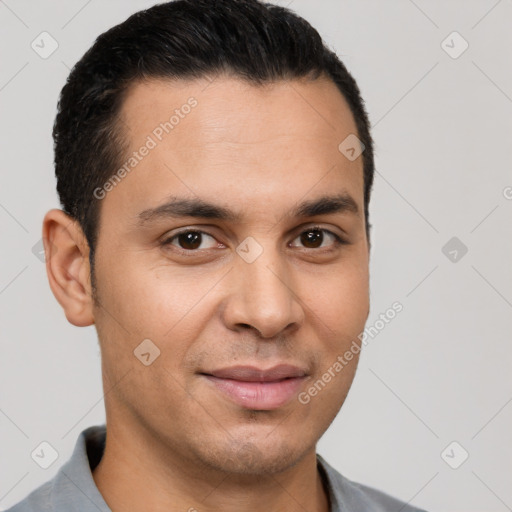 Joyful latino young-adult male with short  brown hair and brown eyes