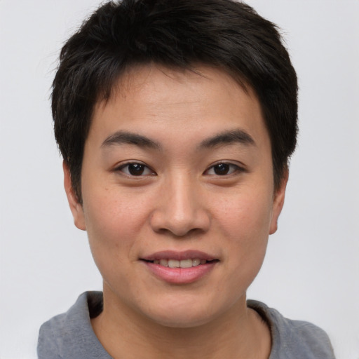 Joyful asian young-adult male with short  brown hair and brown eyes