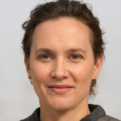 Joyful white adult female with short  brown hair and brown eyes