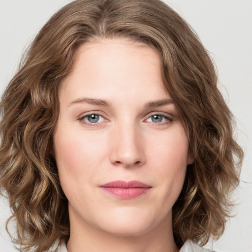 Joyful white young-adult female with medium  brown hair and green eyes