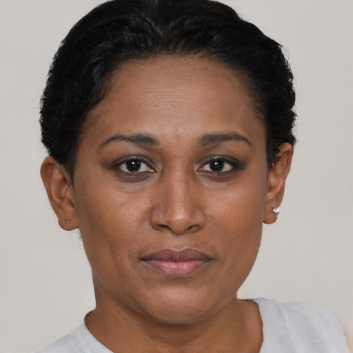 Joyful black adult female with short  black hair and brown eyes
