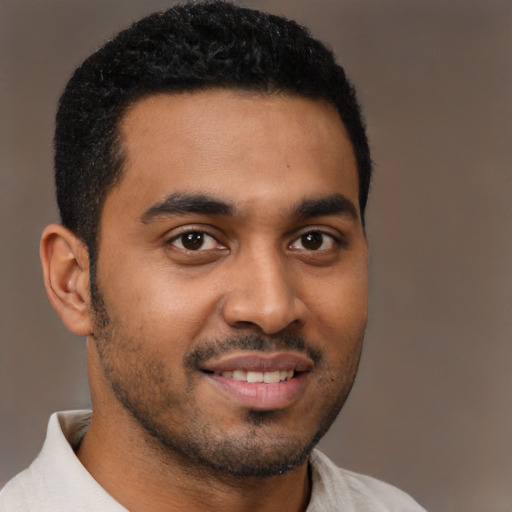 Joyful black young-adult male with short  black hair and brown eyes