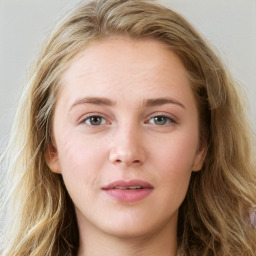 Joyful white young-adult female with long  brown hair and blue eyes