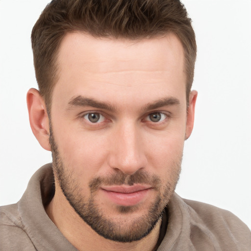 Joyful white young-adult male with short  brown hair and grey eyes