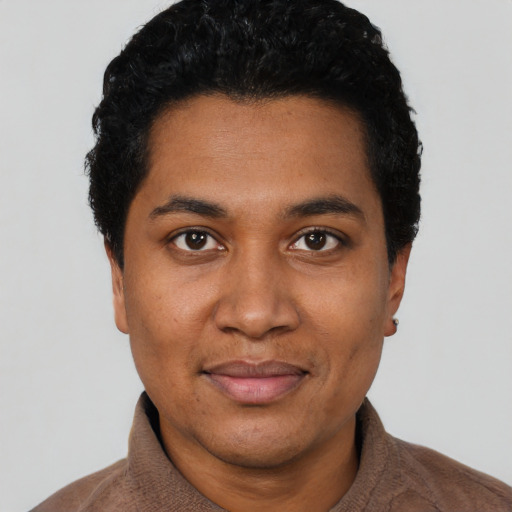 Joyful black young-adult male with short  black hair and brown eyes