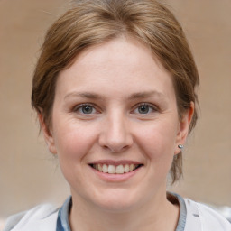 Joyful white young-adult female with medium  brown hair and grey eyes