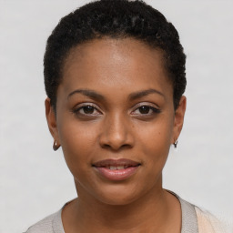 Joyful black young-adult female with short  black hair and brown eyes