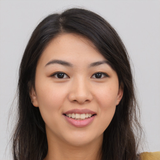 Joyful white young-adult female with long  brown hair and brown eyes