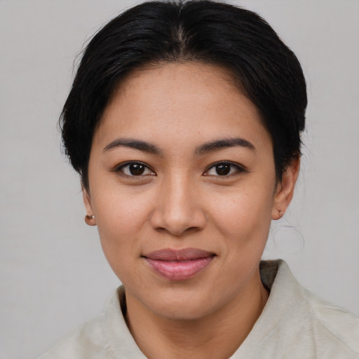 Joyful asian young-adult female with medium  brown hair and brown eyes