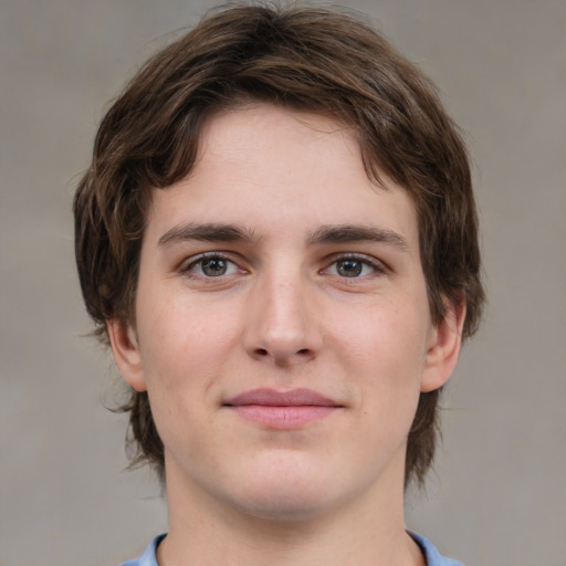 Joyful white young-adult male with medium  brown hair and grey eyes