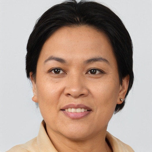 Joyful asian adult female with short  brown hair and brown eyes