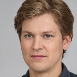 Joyful white adult male with short  brown hair and grey eyes