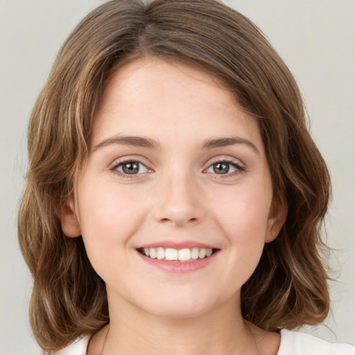 Joyful white young-adult female with medium  brown hair and green eyes