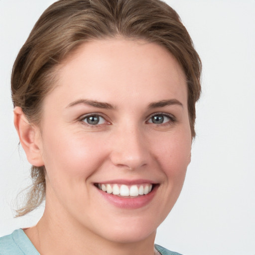 Joyful white young-adult female with medium  brown hair and blue eyes