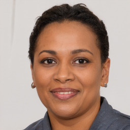 Joyful black adult female with short  brown hair and brown eyes