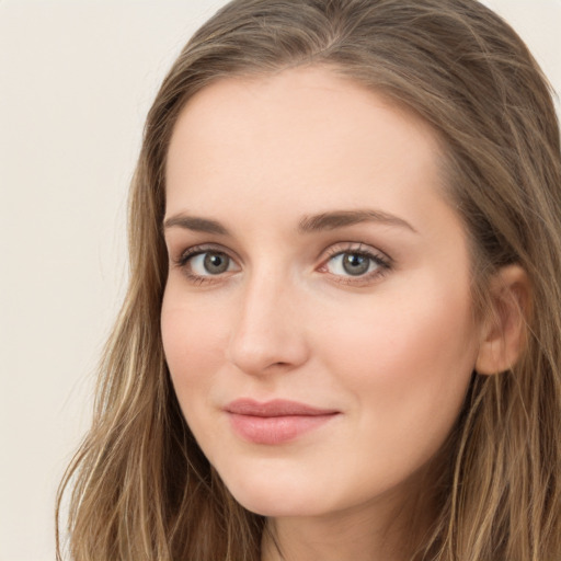 Joyful white young-adult female with long  brown hair and green eyes