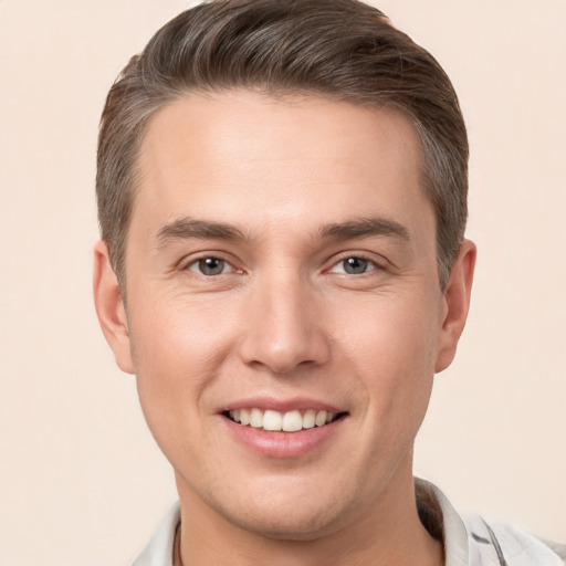 Joyful white young-adult male with short  brown hair and brown eyes