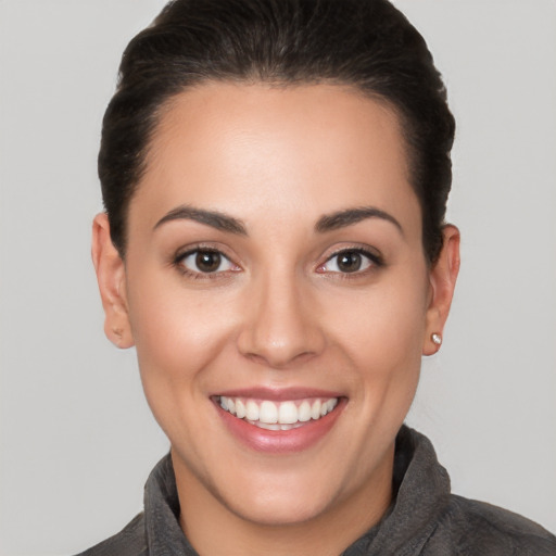 Joyful white young-adult female with short  brown hair and brown eyes