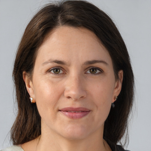 Joyful white adult female with medium  brown hair and brown eyes