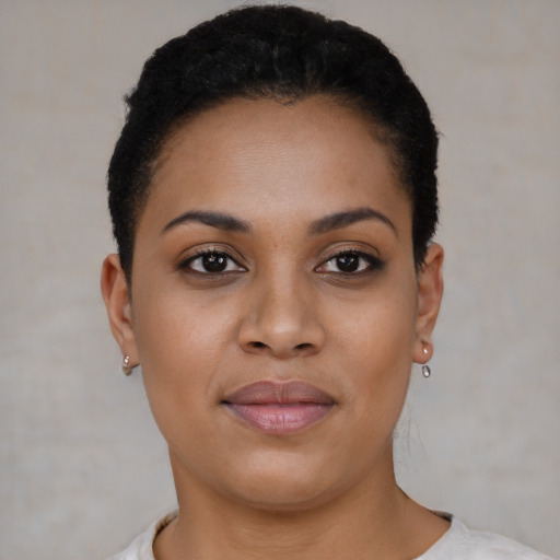 Joyful black young-adult female with short  black hair and brown eyes
