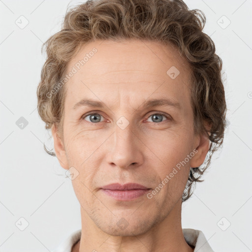 Joyful white adult male with short  brown hair and grey eyes