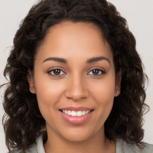 Joyful white young-adult female with long  brown hair and brown eyes