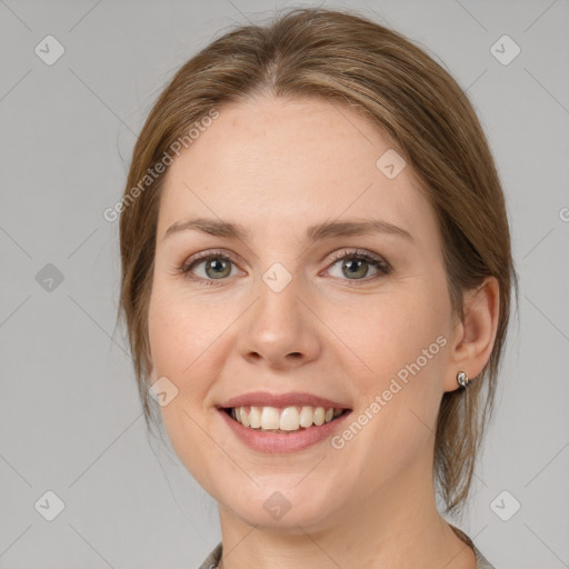 Joyful white young-adult female with medium  brown hair and grey eyes