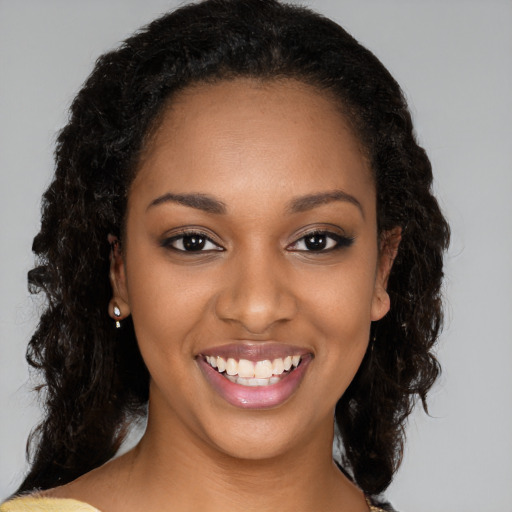 Joyful black young-adult female with medium  black hair and brown eyes