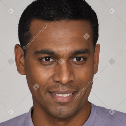 Joyful black young-adult male with short  brown hair and brown eyes