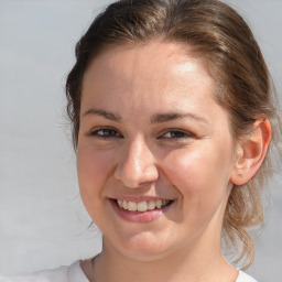 Joyful white young-adult female with medium  brown hair and blue eyes