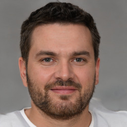 Joyful white young-adult male with short  brown hair and brown eyes
